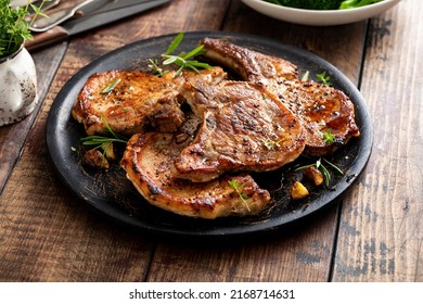 Grilled or pan fried pork chops on the bone with garlic and rosemary - Shutterstock ID 2168714631