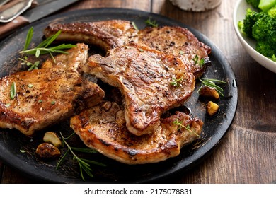 Grilled or pan fried pork chops on the bone with garlic and rosemary - Shutterstock ID 2175078831
