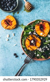 Grilled Peach Summer Salad With Honey Vinaigrette On Blue Background