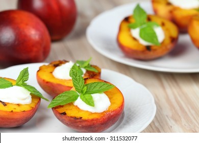 Grilled peaches and mascarpone with mint  leaves