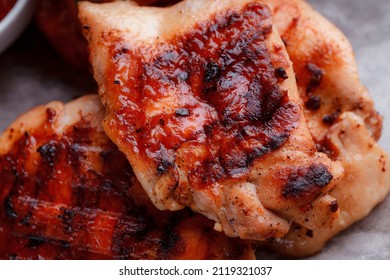 Grilled Piece Of Meat. Crispy Chicken Wings. The Texture Of The Meat Is Very Close Up. Seasoning In The Form Of Ketchup And Sprigs Of Rosemary.