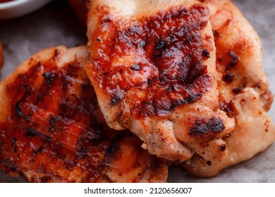 Grilled Piece Of Meat. Crispy Chicken Wings. The Texture Of The Meat Is Very Close Up. Seasoning In The Form Of Ketchup And Sprigs Of Rosemary.