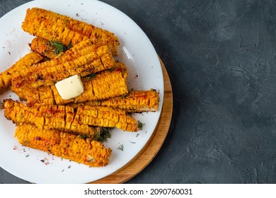 Grilled Pieces Of Corn On The Cob In A White Plate On A Dark Background Free Space. View From Above..