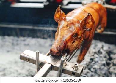 Grilled pig at the street food festival. Roasted pig on the rack. Food. - Shutterstock ID 1810061539