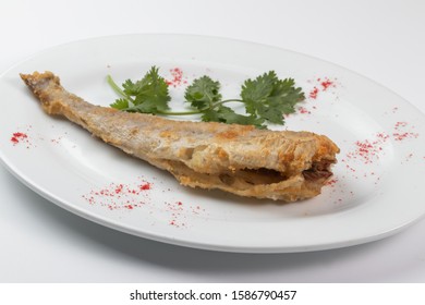 Grilled Pollock On A White Dish