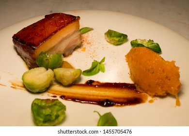 Grilled Pork Accompanied By Baby Vegetables And Sweet Potato Puree