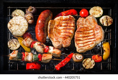 Grilled pork chops  and kebabs with vegetables. Top view