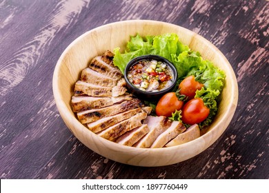 Grilled pork jowl favorite Thai street food on dark wooden background