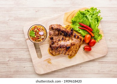 Grilled pork jowl favorite Thai street food on wooden background
