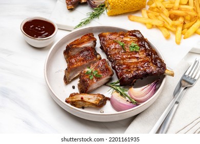 Grilled pork ribs with barbecue sauce and ketchup and grilled vegetables - Powered by Shutterstock