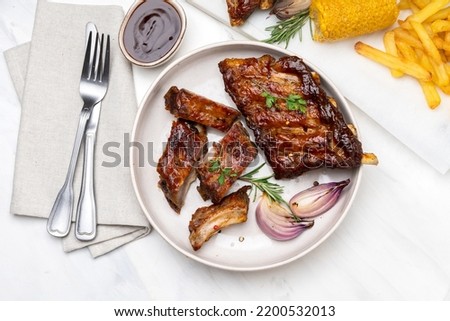 Grilled pork ribs with barbecue sauce  and grilled vegetables. top view 