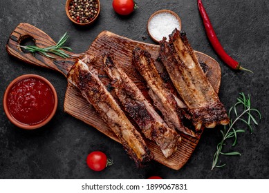 grilled pork ribs on a stone background - Shutterstock ID 1899067831