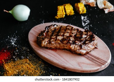 Grilled pork steak on a wooden board - Shutterstock ID 1841807902
