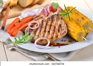 Grilled pork steaks with corncobs and salad - Powered by Shutterstock