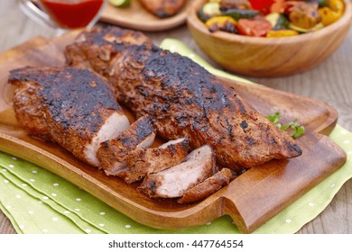 Grilled Pork Tenderloin Served On A Wooden Board