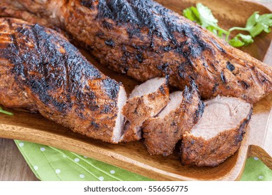 Grilled Pork Tenderloin Served On A Wooden Board