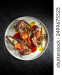 Grilled rack of lamb chops with vegetables, Roasted Australian lamb rack served with on white plate, top view, black background.