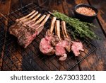 Grilled Rack of lamb, mutton meat chop steaks with thyme. wooden background. top view.