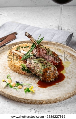 Grilled racks of lamb with demiglas sauce and vegetables on a plate. Main course of lamb on the bone, close up
