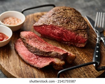 Grilled ramp cap steak on a cutting board. Barbecue Grilled rump cap or brazilian picanha beef meat steak in a wooden tray. - Shutterstock ID 2141755587