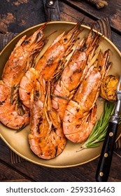 Camarones argentinos rojos a la parrilla, Langostino Austral en un plato con hierbas. fondo de madera. vista superior.