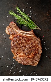 Grilled Ribeye Steak With Spices On Stone Background