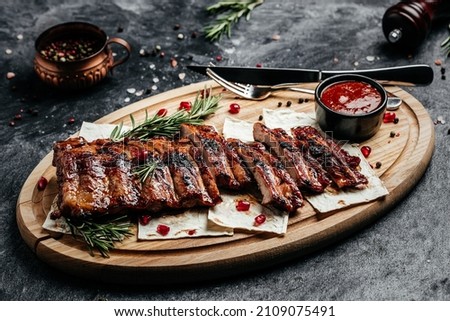Grilled ribs on cutting board. Restaurant menu, dieting, cookbook recipe top view.
