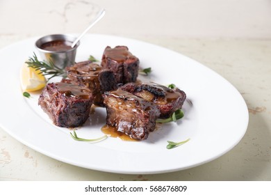 Grilled Ribs Served Over Big White Plate