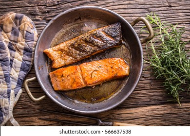 Grilled Salmon Fillets And Herb Decoration In Old Roasted Pan. 