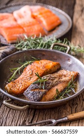 Grilled Salmon Fillets And Herb Decoration In Old Roasted Pan. 