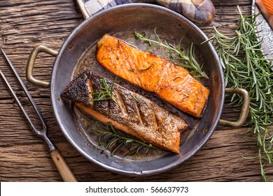 Grilled Salmon Fillets And Herb Decoration In Old Roasted Pan. 