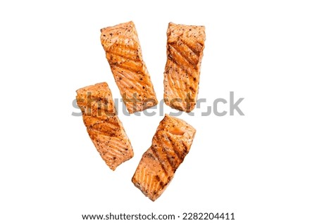 Grilled salmon fillets steaks with salt pepper and herb on grill. Isolated on white background