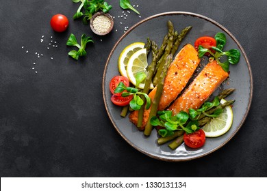 Grilled Salmon Fish Steak, Asparagus, Tomato And Corn Salad On Plate. Healthy Dish For Lunch. Top View