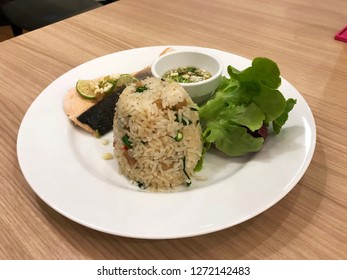 Grilled salmon fried rice in a white plate