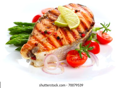 grilled salmon with lime, asparagus and cherry tomatoes on white plate - Powered by Shutterstock