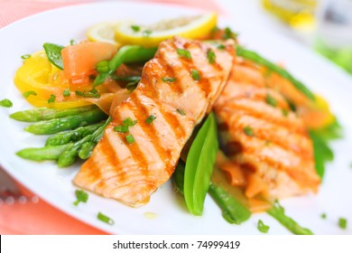 grilled salmon with spring vegetables on white plate, soft focus - Powered by Shutterstock