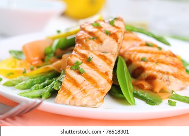 grilled salmon with spring vegetables on white plate, soft focus - Powered by Shutterstock - Get 15% off with code: PIKWIZARD15