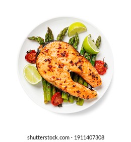 Grilled Salmon Steak With Asparagus And Tomatoes Cherry On A White  Plate Isolated On White  Background. Top View