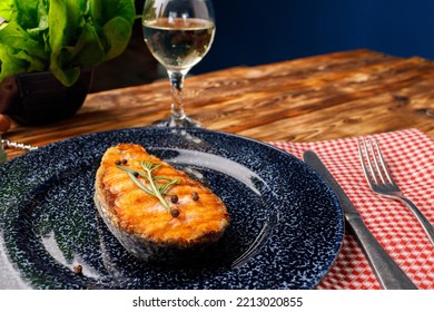 Grilled Salmon Steak On Blue Plate On Wooden Table