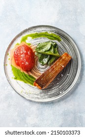 Grilled Salmon Steak With Spinach Leaves, Tomato And Green Oil. Overhead View, Copy Space