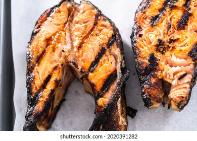 Grilled Salmon Steaks On A Baking Sheet With Parchment Paper.