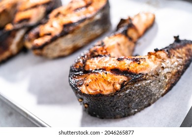 Grilled Salmon Steaks On A Baking Sheet With Parchment Paper.