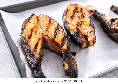 Grilled Salmon Steaks On A Baking Sheet With Parchment Paper.