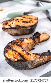 Grilled Salmon Steaks On A Baking Sheet With Parchment Paper.