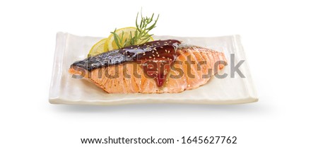 Grilled salmon teriyaki on white plate, isolated on whit background with clipping path.