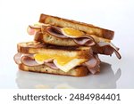 grilled sandwiches on toasted bread, featuring freshly sliced ham, melted cheese, and a per