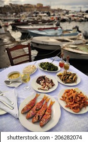 Grilled Sardine, Octopus, Shrimp With Olive Oil And White Wine, Traditional Greek Food At The Restaurant Near The Bay, Island Of Crete, Greece