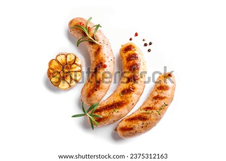 Grilled sausages with garlic and rosemary isolated on white background, top view, copy space. Roasted homemade wurst sausages.
