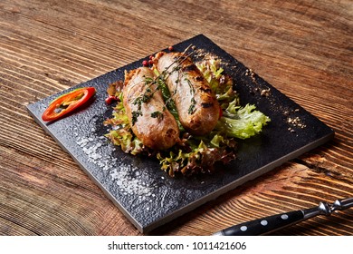 Grilled sausages on the black board on wooden background - Shutterstock ID 1011421606