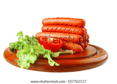 grilled sausages served on wooden plate over white